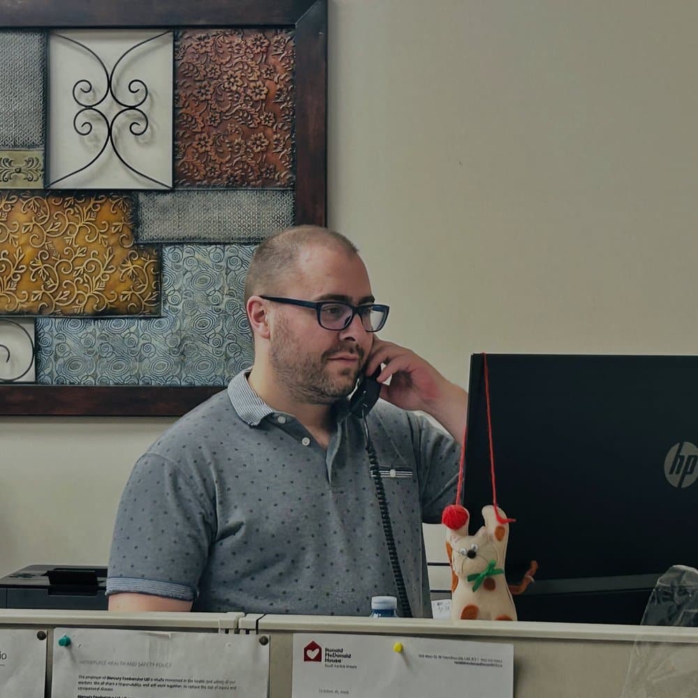 A Mercury Foodservice team member taking an order at the desk