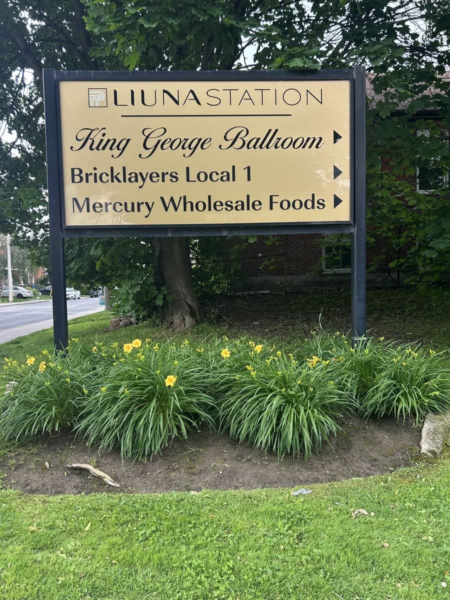 LIUNA Station directional sign listing Mercury Wholesale Foods alongside King George Ballroom and Bricklayers Local